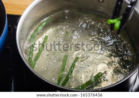 Green beans in boiling water in a cook pot