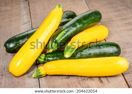 Zucchini and yellow squash on a wooden table