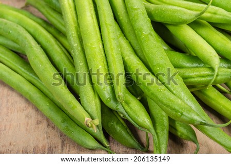 Fresh green beans or snap beans on a wooden table