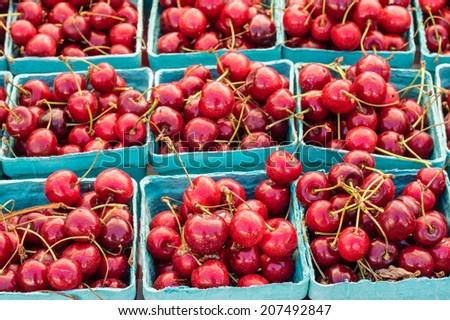 Freshly picked sweet red cherries in boxes at the market