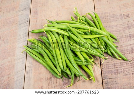 Freshly picked green or snap beans on a wooden table