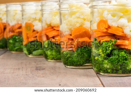 Jars of fresh cut vegetables ready to prepare for preserving