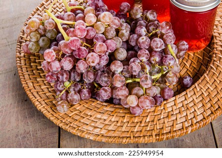 Jars of fresh pink grape jelly with grapes