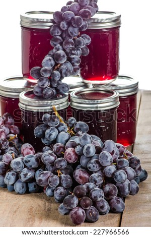 Bunches of grapes on jelly jars isolated