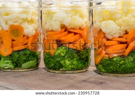 Jars of fresh cut vegetables ready to prepare for preserving