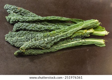Fresh green kale leaves on black counter