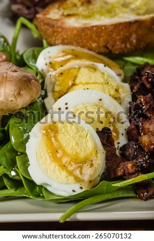 Spinach and egg salad with sliced hard boiled eggs