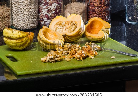Winter acorn squash hollowed and seeds removed on cutting board
