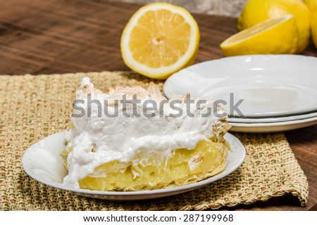 Slice of lemon meringue pie on white serving plate