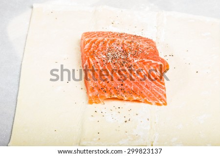 Salmon fillet seasoned and wrapped in dough ready to bake