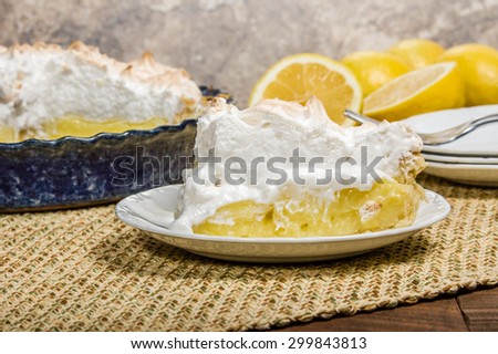 Slice of lemon meringue pie on white serving plate