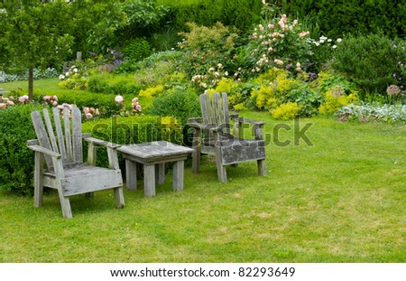 A pair of chairs and small table in the garden