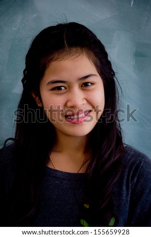 smiling Asian woman with braces