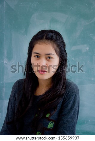 smiling Asian woman on green background