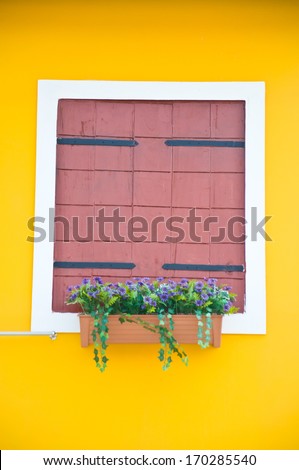 brown window frame on yellow background