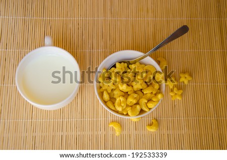 yellow cereal with milk for breakfast meal