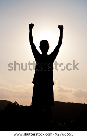 Silhouette of free boy happy and victory
