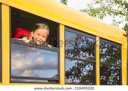 Little Schoolgirl looking through a Schoolbus Window Little Schoolgirl looking through a Schoolbus Window