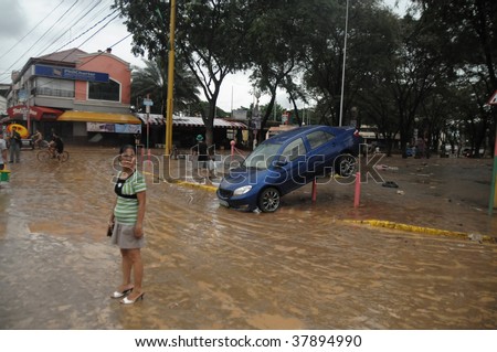 PHILIPPINES – CIRCA SEPT 2009:A car is left useless at Marikina street circa Sept 2009 in the Philippines. Typhoon Ondoy left hundreds of thousand families displaced and killed hundreds of people