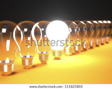 Isolated Light Bulbs in line on orange background