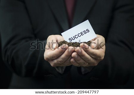 White Business card in hands on the ground