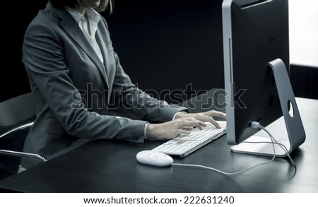 Businesswoman typing at computer