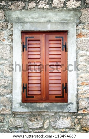 Brown wooden shutters in old stone house, Croatia