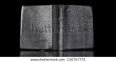 Old leather book cover, vintage texture reflected in black surface