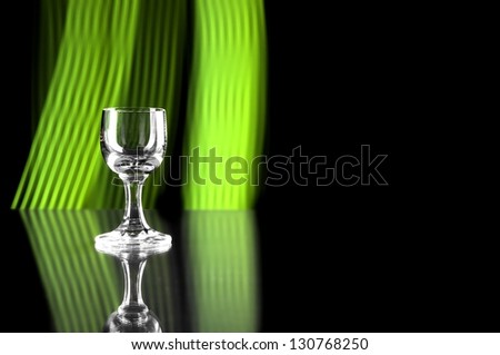 Glass of alcohol on disco background, party atmosphere, copyspace