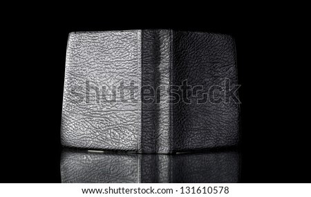 Old leather book cover, vintage object reflected in black surface