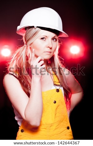 Young architect woman construction worker thinking, glowing lights