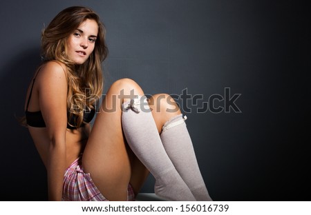 Sexy young woman wearing socks and lingerie, sensual looking