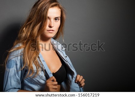 Portrait of hot woman in denim jeans shirt jacket and black bra