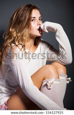 Sexy young woman wearing socks and white long sleeve t-shirt