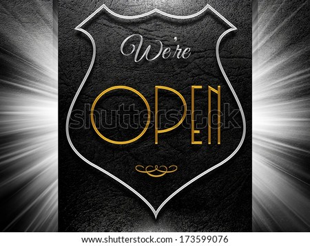 We're open sign on black leather background