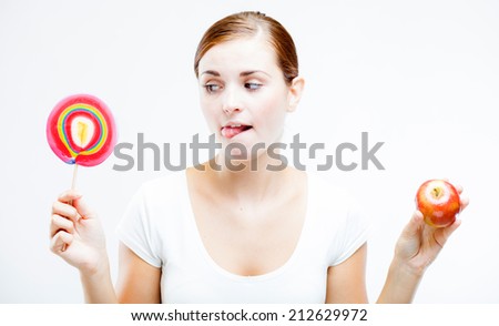 Woman choosing between sweets and fruits, healthy or unhealthy food concept