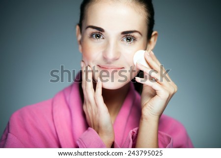 Beauty fresh girl cleaning face with cotton swab