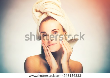 Healthy fresh girl cleaning face with cotton swab