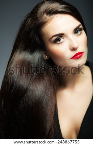 Beautiful glamour woman with dark shiny long hair and red lips