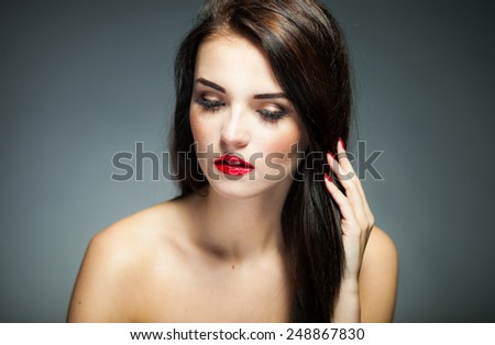 Natural woman face with red lips, nails and long hair on dark background 2