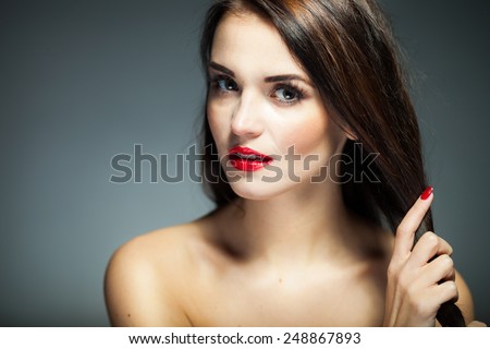Natural woman face with red lips, nails and long hair on dark background 2