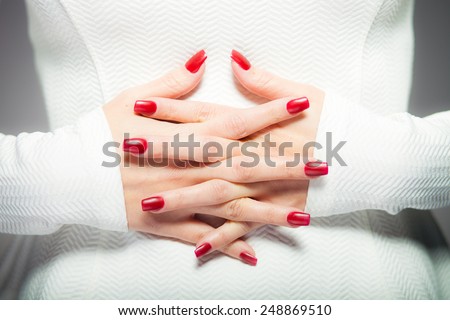 Woman showing her red nails, manicure concept