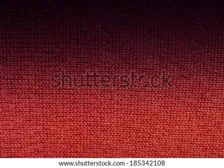 Red wool knit work fade to black. Red wool knit work full frame for warming backdrop or background.