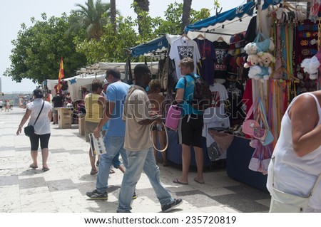 TORREVIEJA, SPAIN - JULY 26, 2012: Market stalls open in the afternoon to serve the crowds of tourists searching for the perfect souvenirs on July 26 2012 in Torrevieja, Spain.