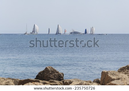 CALA ESTANCIA, MAJORCA, SPAIN - JULY 21 2012: Sailboats with full sails participating in the yearly sailing competition Copa del Rei regatta on July 21 2012. Palma de Mallorca, Balearic islands, Spain