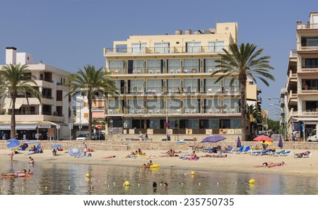 CALA ESTANCIA, MAJORCA, SPAIN - JULY 21 2012: Hotel buildings and tourists celebrating summer holidays, living beach life on July 21 2012 in Cala Estancia, Majorca, Balearic islands, Spain.