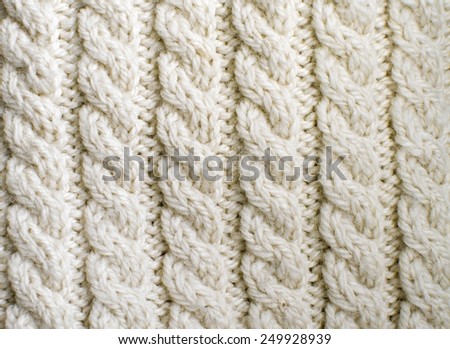 Creamy off-white handmade wool knitwork. Creamy off-white wool knitwork full frame for warming artisan backdrop or background.