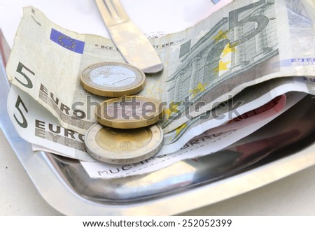 Euro bills and exchange coins in a restaurant. Majorca, Spain.