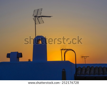 Spanish roof with interesting and decorative antennas at sunset Majorca, Spain.