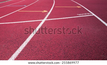 Red running field track with arrows and lines.